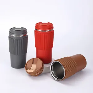 Detailed macro view of insulated 304 stainless steel coffee mugs with textured sleeves