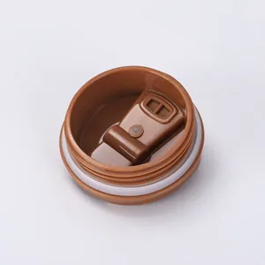 Detailed close-up view of the brown insulated coffee cup lid showing the silicone seal