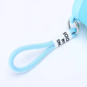 Close-up of a light blue braided carrying strap with label for a soda can shaped thermos cup