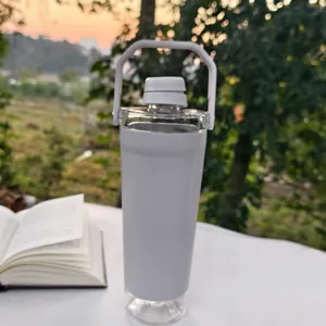 Detailed view of white shaker bottle with handle and storage base in outdoor setting