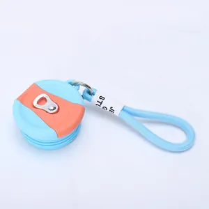 Detail of a light blue can-shaped lid with an orange accent and woven lanyard loop