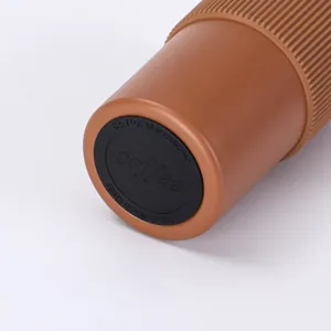 Close-up detail of the brown insulated coffee mug bottom with washing instructions