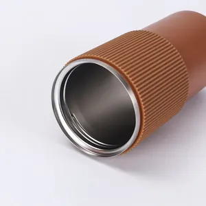 Close-up of 304 stainless steel coffee tumbler with brown ribbed silicone sleeve