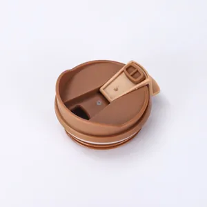 Detailed view of a brown spill-proof flip-top lid for insulated coffee tumblers.