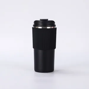Detailed side view of a minimalist black stainless steel vacuum insulated coffee cup