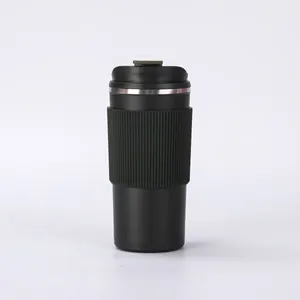 Sleek matte black vacuum insulated coffee tumbler with textured non-slip silicone grip sleeve