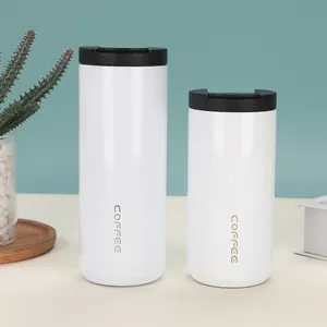 Detailed view of two white stainless steel vacuum coffee mugs in different sizes on a desk