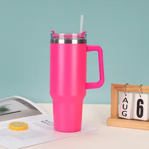 A detailed macro view of a vibrant pink 40oz insulated tumbler with a handle and straw