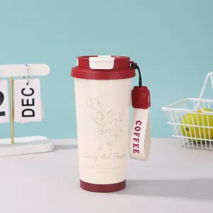 Detail der cremefarbenen 316 Edelstahl-Kaffeetasse mit Maiglöckchen-Muster und Tragegurt