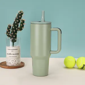 Close-up detail of a 40oz sage green insulated tumbler with a handle and straw.