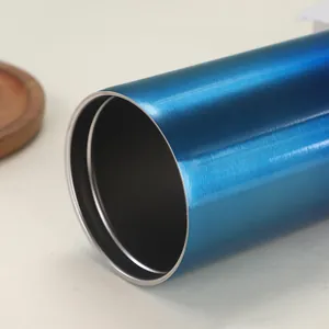 Detailed macro view showing the brushed metal finish of a blue insulated coffee mug