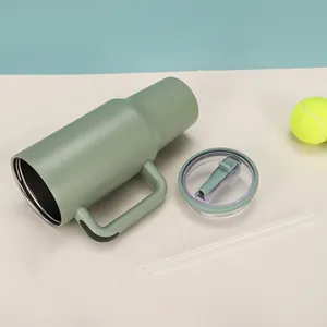 Olive green 40oz insulated tumbler with clear lid and straw on a cream surface.