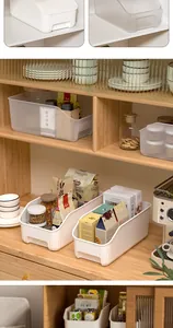 Detailed view of rectangular plastic storage bins organizing snacks in a pantry