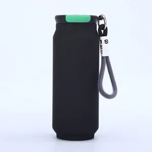 Detailed view of the green lid mechanism and woven strap on a matte black soda can cup
