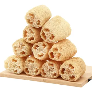 Set of natural loofah sponges stacked on a bamboo board for eco-friendly kitchen cleaning.