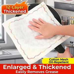 12-layer thickened white cotton mesh dishcloth being used to wipe a black frying pan
