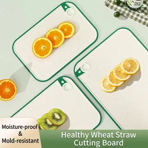 Wheat straw cutting board set with non-slip green borders and fruit slices display