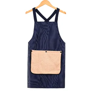 Waterproof navy blue striped kitchen apron featuring a large beige pocket and cross-back design
