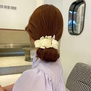 Detail of vintage cream satin rose hair bun maker accessory for women's hairstyle