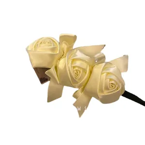 Vintage cream satin rose hair bun maker accessory with elegant ribbon bow accents