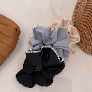 Close-up detail of premium satin scrunchies in three colors featuring sparkling rhinestone trim.