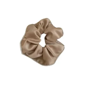 Elegant champagne silk scrunchie with sparkling rhinestone trim for vintage look.