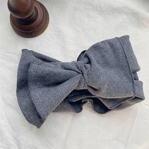 Close-up of a vintage grey ribbed cotton headband with a large bow detail