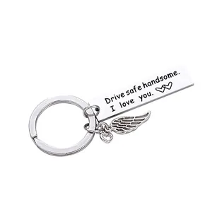 Detail showing engraved message and angel wing charm on stainless steel keychain