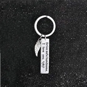 Macro view of stainless steel keychain with Drive safe handsome engraving and angel wing