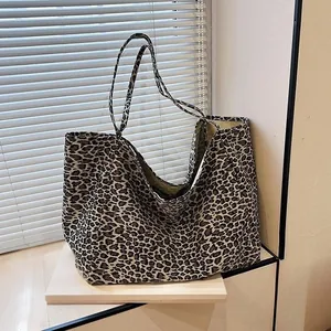 Large leopard print canvas tote bag in a stylish lifestyle indoor setting