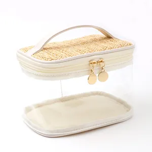 Clear PVC and straw travel toiletry bag with white handle and gold zippers.