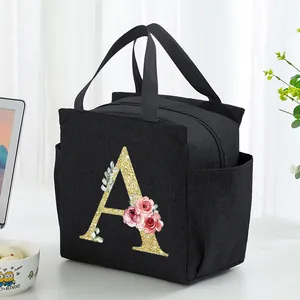 Close-up of black insulated lunch bag featuring a floral glittery letter A design.
