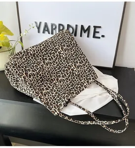 Close-up detail of the leopard print pattern on a large stylish canvas tote bag
