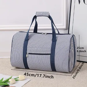 Large striped seersucker travel bag with dimensions 45x25x25cm shown in lifestyle setting
