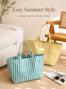 Detailed view of blue and yellow striped canvas tote bags in a cozy sunlit room setting.