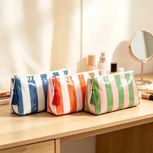 Set de tres neceseres de rayas en PVC brillante con borlas de colores vivos