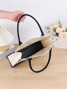 Detailed interior view of a large capacity canvas tote bag with black rope handles