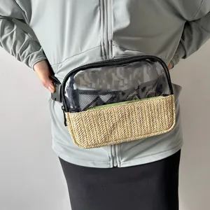 Detailed view of a clear PVC and straw woven waist bag worn on the model's waist.
