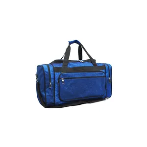 Macro view of blue glittery travel bag showing multiple zipper compartments and texture