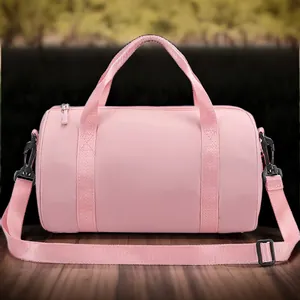 Minimalist pink waterproof cylinder duffel bag for dance and fitness on wooden table