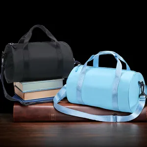 Waterproof cylindrical gym and dance bags in black and light blue shown with straps
