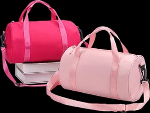 Two waterproof cylindrical gym bags in vibrant hot pink and soft baby pink tones