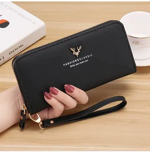 Detailed view of black litchi grain long zipper wallet with gold deer ornament