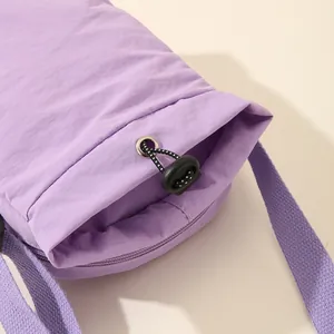 Close-up of purple nylon water bottle bag with functional drawstring and strap detail