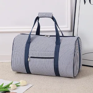 Macro view of blue and white striped seersucker travel bag featuring sturdy woven handles