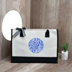 Close-up of a stylish canvas tote bag featuring a blue floral print and striped bow