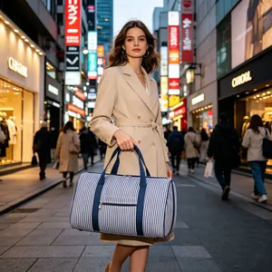 Large striped seersucker duffel bag for gym and travel held by a model