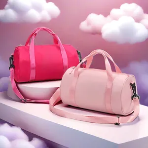 Two stylish pink waterproof cylindrical gym bags displayed on a dreamy cloud background