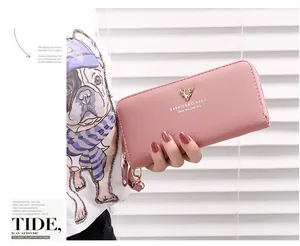 Detailed shot of a pink long zipper wallet featuring lychee texture and gold deer logo