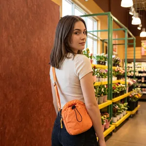 Vibrant orange nylon drawstring crossbody bag for outdoor hiking and casual travel